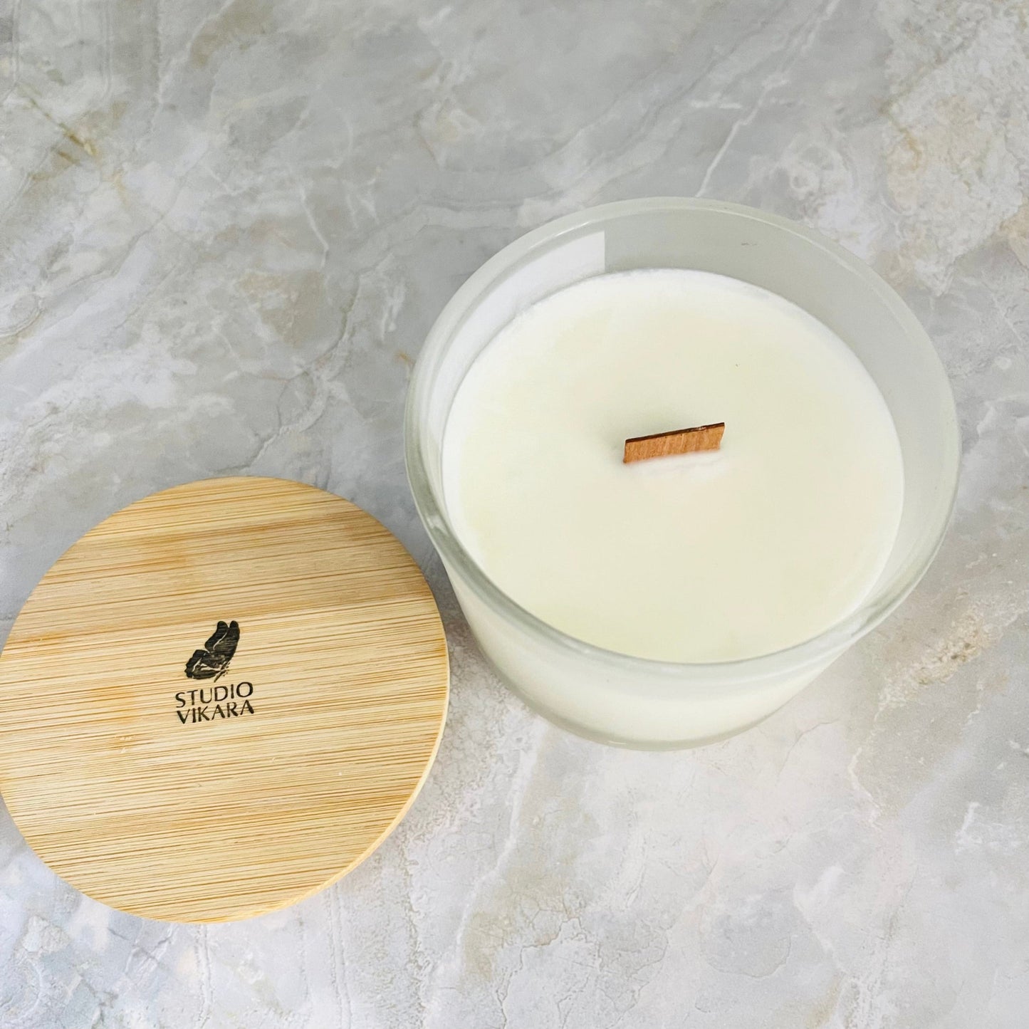 10oz Cracking wood wick in a open candle jar with wooden lid branded Studio Vikara