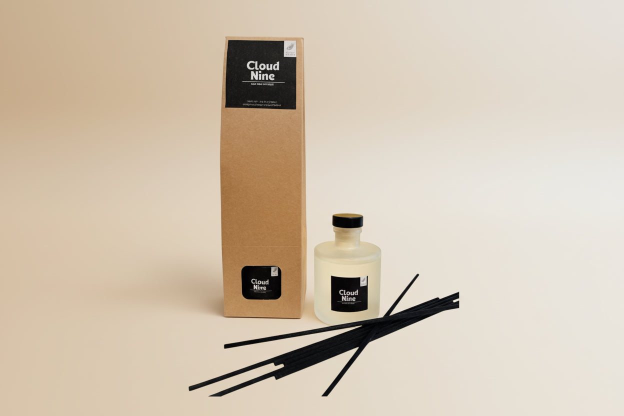 Cloud Nine diffuser set with bottle, reeds, and packaging on a marble surface